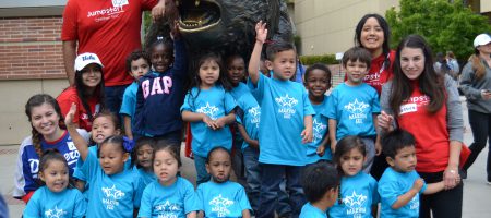 Preschoolers from some of the schools served by Jumpstart UCLA gather for a quick photo with the Bruin Bear