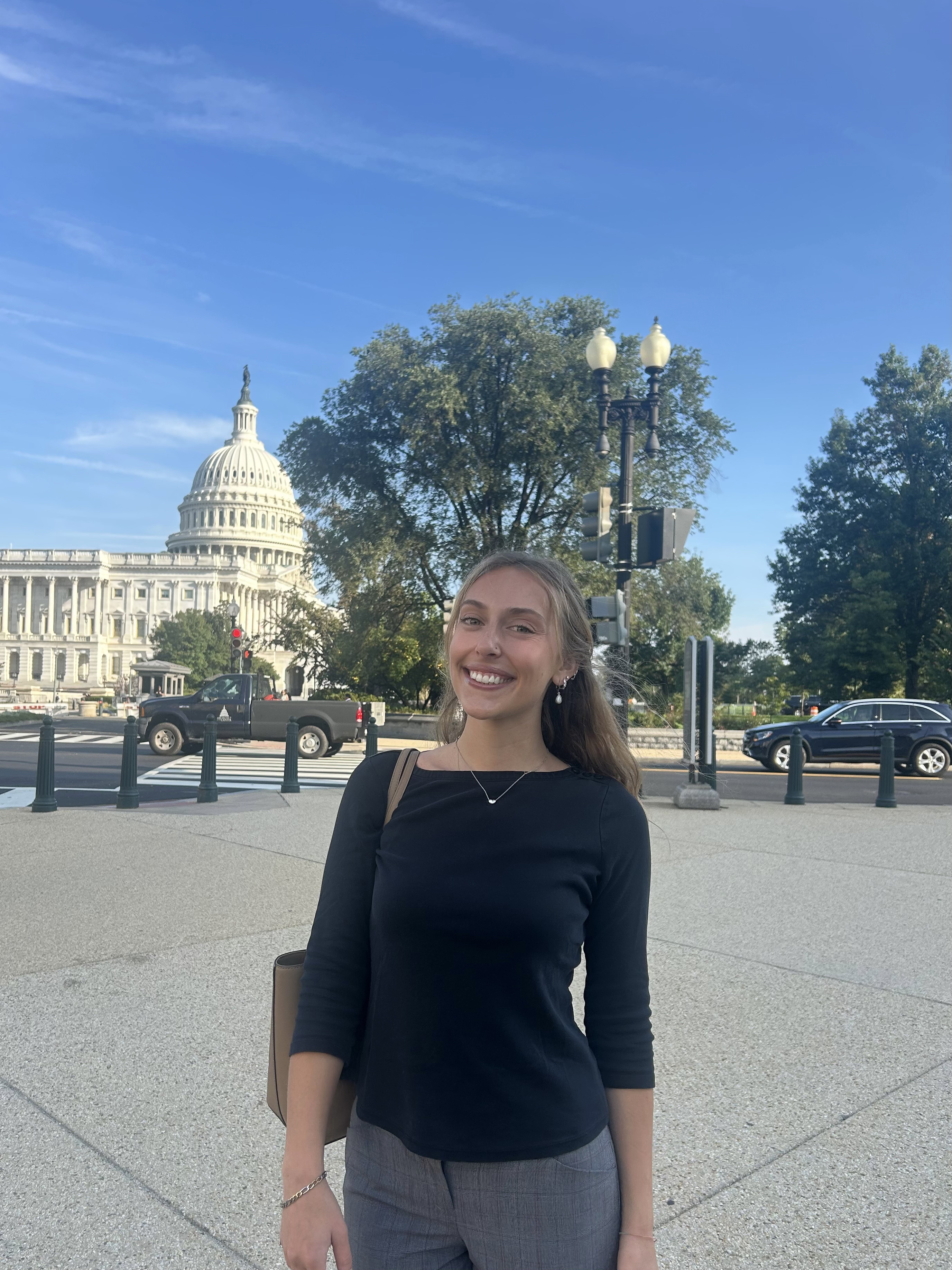 Photo of Devon Clark. She wears a black shirt in front of the US Capitol building on her first day of work as a Congressional Intern in Washington DC.